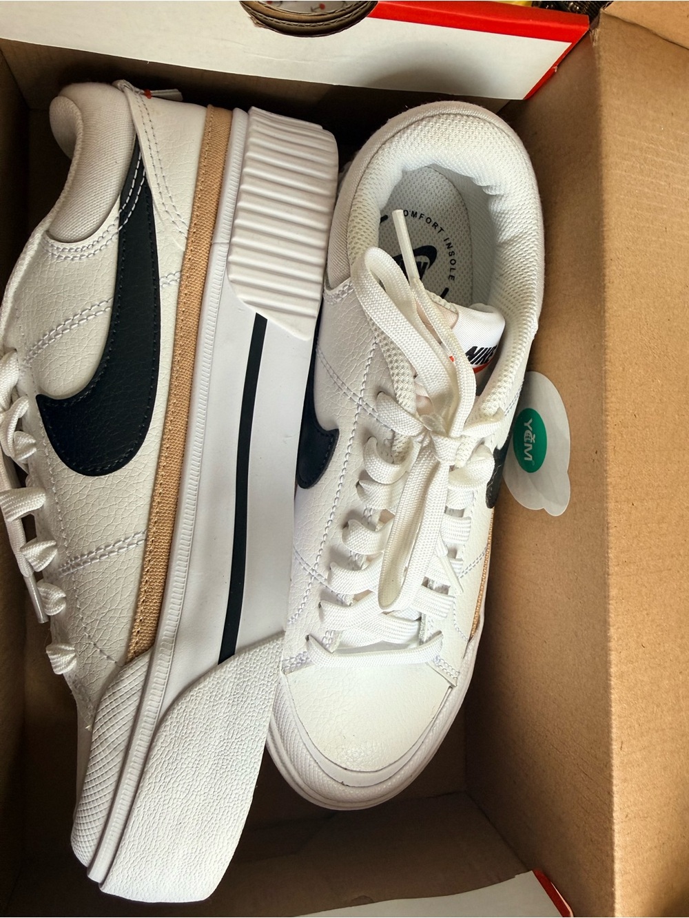 Nike White Sneakers with Black Swoosh and Tan Accent